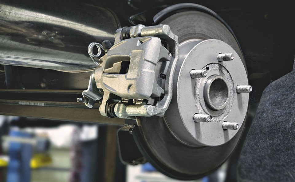 An image of clean, new brakes just installed on a car wheel.