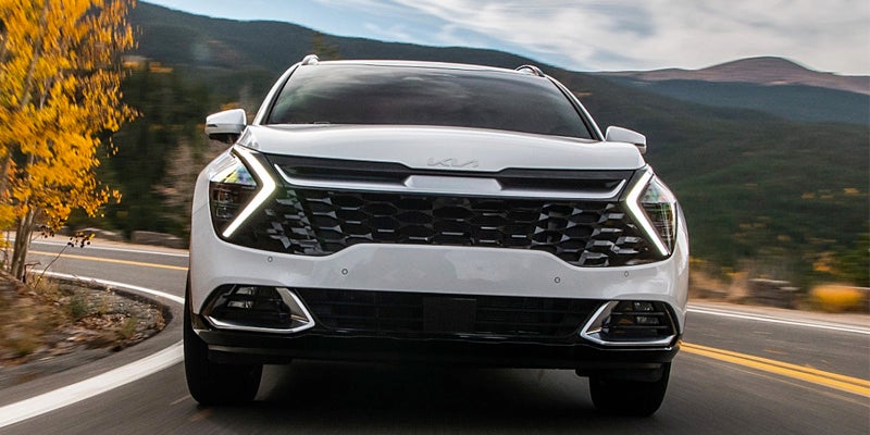 A white Kia Sportage shot head-on.